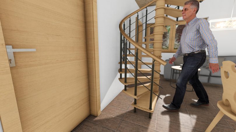 Ein Mann geht die spiralförmige Treppe in einem modernen Raum hinauf.
