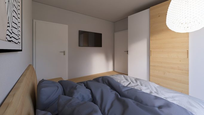 Helles Schlafzimmer mit einem Bett, einem Fernseher und einem modernen Schrank.