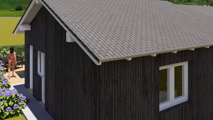 Schwarzes Holzhaus mit einem geneigten Dach und großen Fenstern in ländlicher Umgebung.