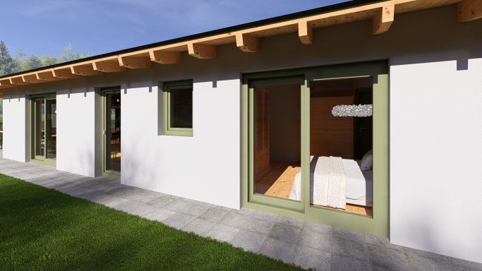 Modernes Haus mit hellen Wänden, großen Fenstern und grünem Dach. Gartenfläche im Vordergrund.